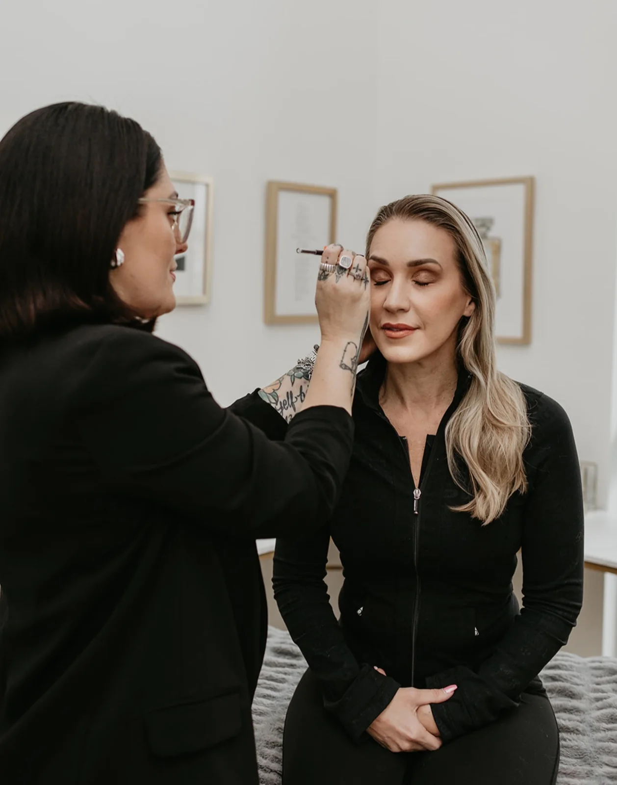 Cher talking a client through her brow shape before the treatment begins